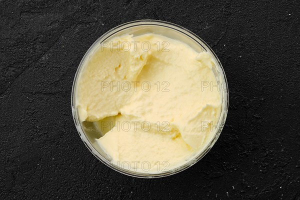 Homemade mascarpone in plastic bowl