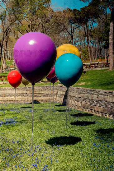 Decorative colorful balloons in the flower garden