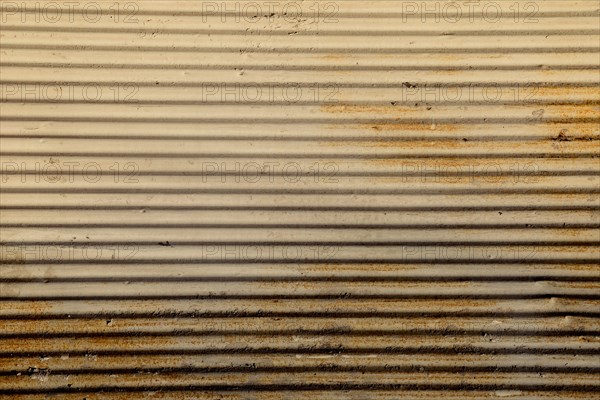 Straight lines on a shop front shutter as a metal background