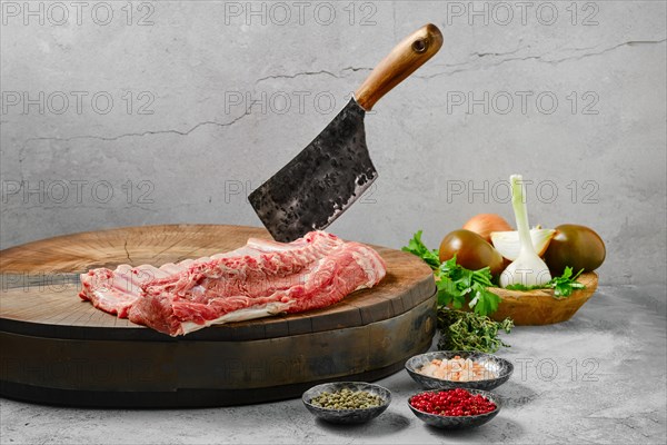 Raw whole rack of lamb on wooden slab