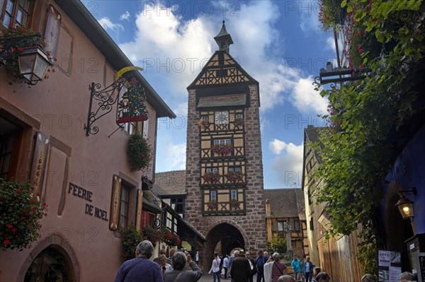 Colourful half-timbered houses with old tower of the historic old town of Riquewihr