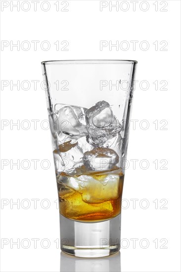 Highball glass with ice and whiskey isolated on white