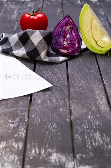 Fresh vegetables on wooden board with a napkin on a table