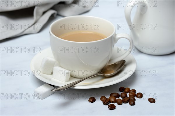 Cup with latte and coffee beans