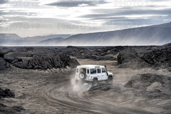 White Land Rover on a dirt road