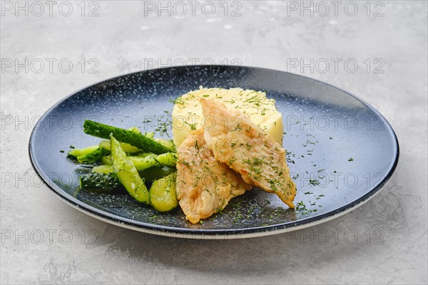 Fried zander fillet in breading with mashed potatoe and pickled cucumber