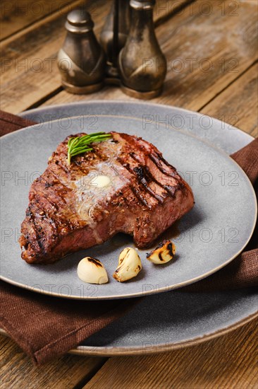 Closeup view of beef steak with a piece of butter on the top