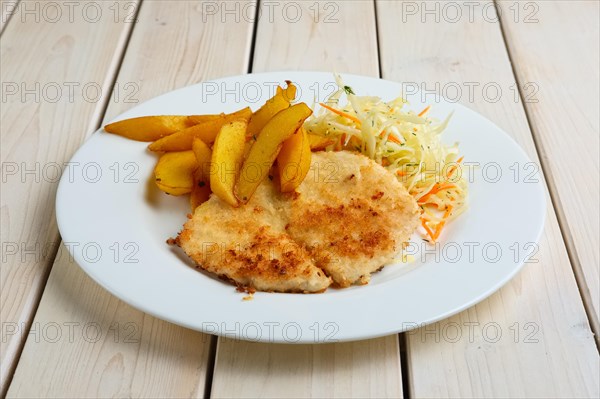 Chop cutlet with fried potato and fresh cabbage and carrot