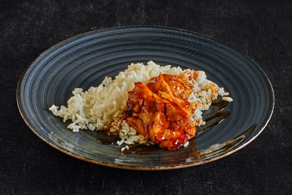 Baked chicken fillet with rice and barbecue sauce