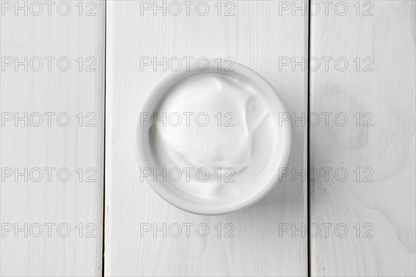 Top view of sour cream in ceramic gravy boat