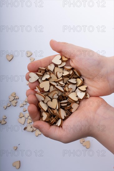 Retro style wooden hearts in hand as love concept