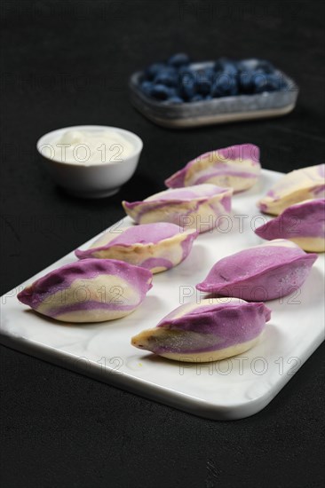 Frozen pierogi with blueberry and sour cream