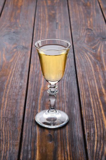 Vodka infused with berries on wooden background