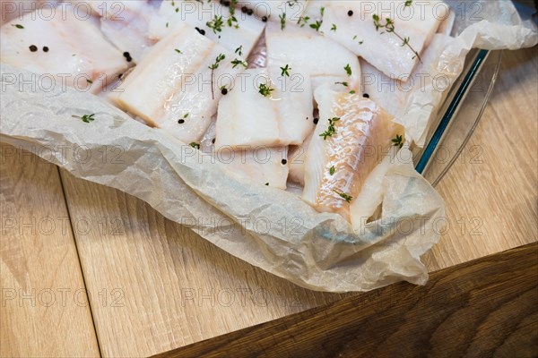 Fresh white fish fillet on cooking paper