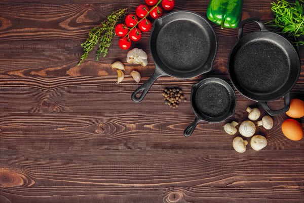 Table with cast-iron pan and spices