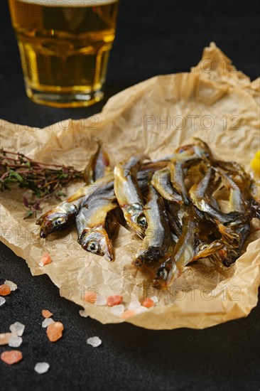 Closeup view of smoked smelt in wrapping paper