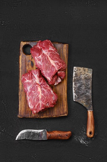 Overhead view of raw fresh lamb boneless neck meat on cutting board