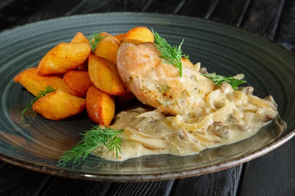 Potato balls with chicken fillet and mushroom and onion sauce