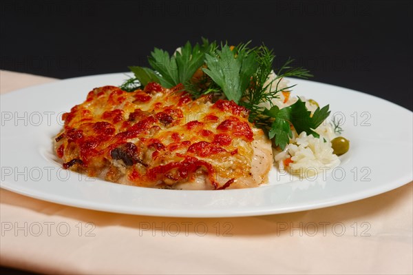 Plate with baked chopped chicken fillet with cheese and rice