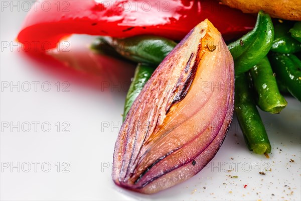 Macro photo of roasted red onion as part of vegetable salad