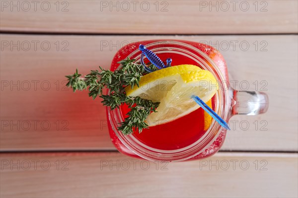Cup of cranberry juice with citrus and rosemary