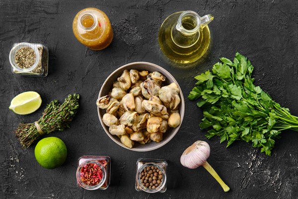 Top view of mussels in bowl with spice and herbs