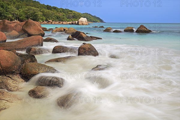 Granite rocks and beach of Anse Lazio in the evening