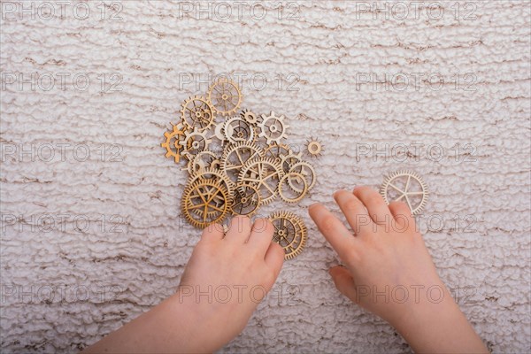 Hand holding gear wheels as the concept of mechanism