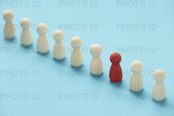 Red pawn surrounded by white ones. Resolution and high quality beautiful photo