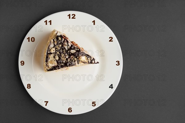 Napoleon layered cake on plate with clock face. Top view