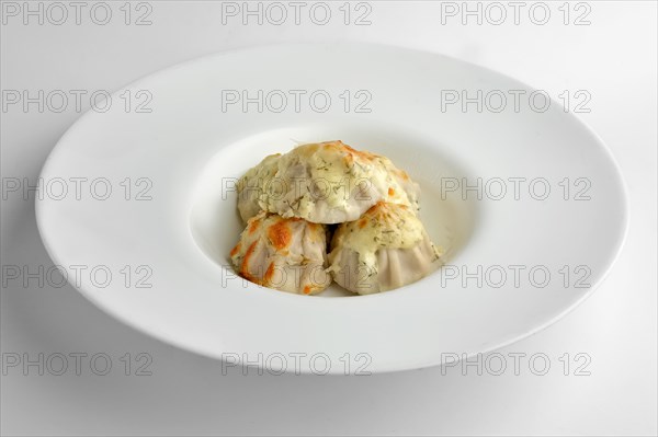 Deep plate with fried pelmeni with cheese