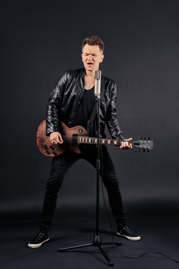 Full length portrait of artist playing guitar