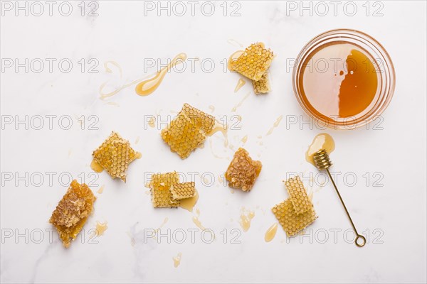 Glass jar full honey with honey spoon