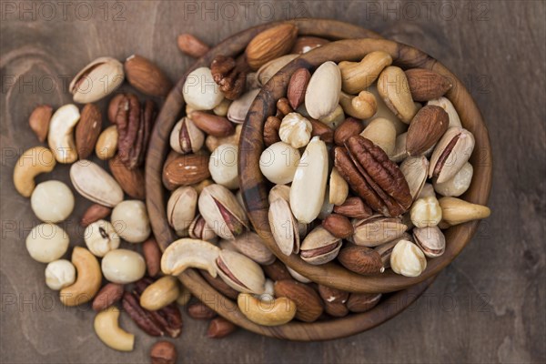 Pile bowls filled with organic nuts top view