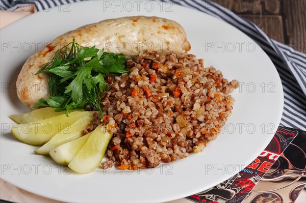 Fried homemade sausage with buckwheat and carrot