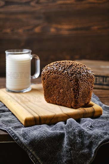 Fresh rye brown bread on wooden cutting board