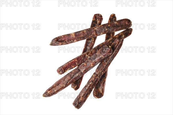 Top view of dried jerked deer and pork sausage isolated on white background