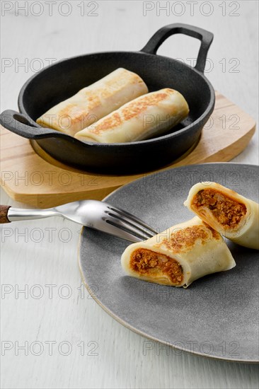 Thin pancakes stuffed with rabbit meat