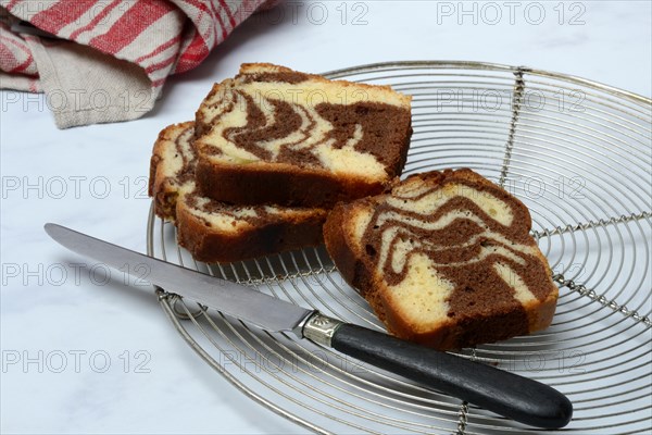 Marble cake and knife on cake rack