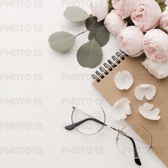 Rose flowers with leaves arrangement with glasses high view