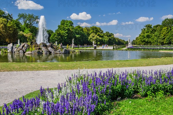 Baroque garden parterre with water fountain in the palace park of Nymphenburg Palace