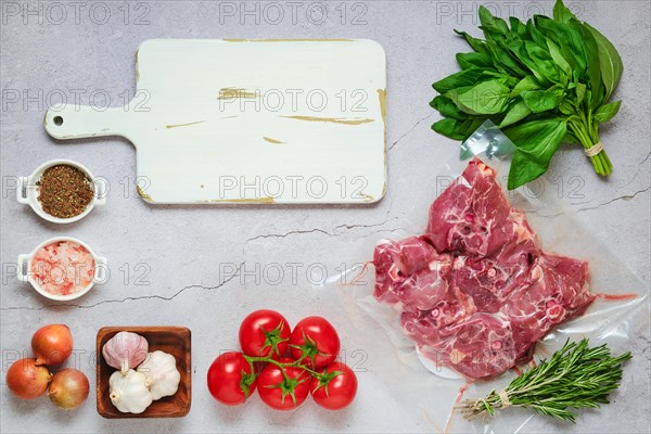 Vacuum sealed lamb neck meat with ingredients for cooking