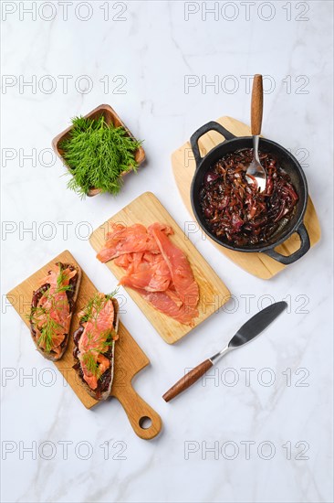 Overhead composition with salmon sandwich with caramelised onion