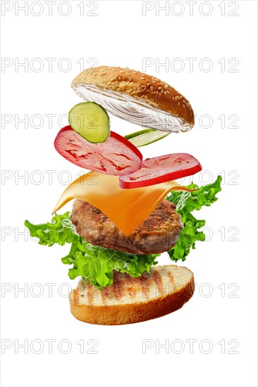 Burger with flying ingredients isolated on white background