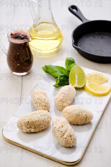 Top view of brown salmon meat cutlet in cheese breading