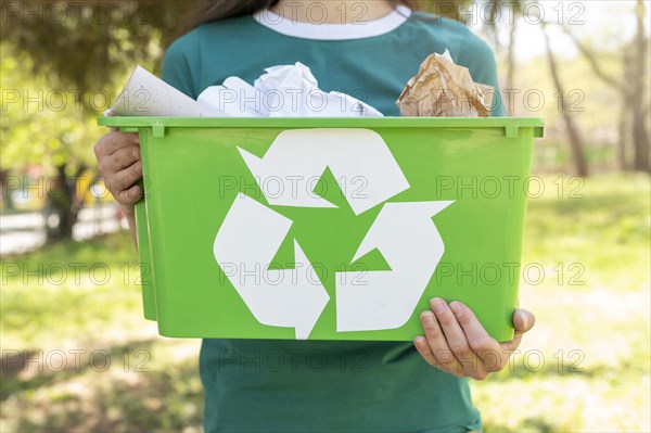 Close up woman holding recycling basket nature