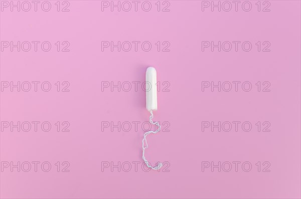 Minimalist tampon pink background top view