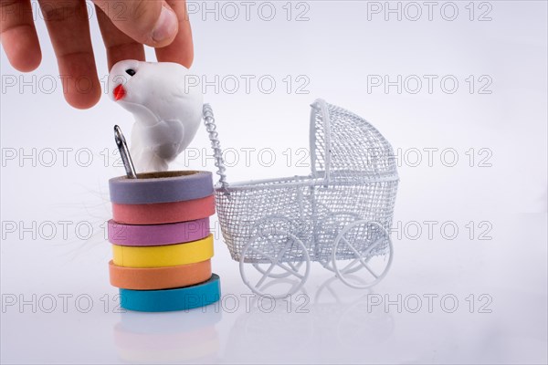 Baby carriage and a fake bird on a white background