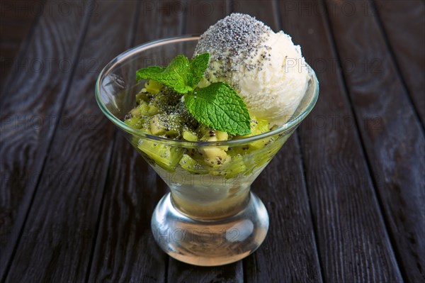 A cup of apple ice cream decorated with kiwi