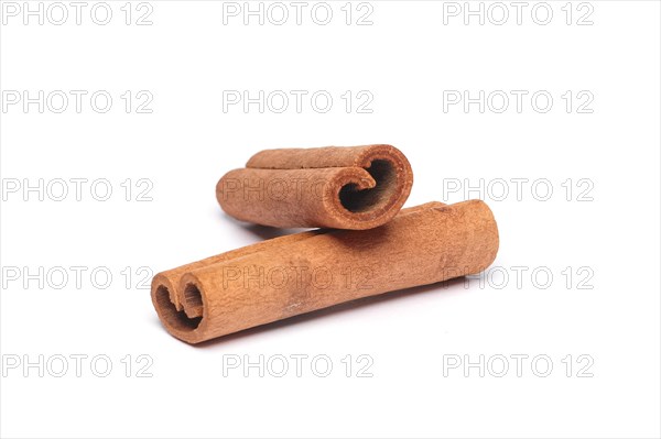 Two cinnamon sticks on white background with shadow